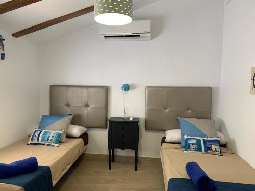 a room with two beds and a table in it at A867 - La Rodeta in Callosa de Ensarriá