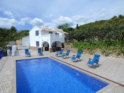 a villa with a swimming pool with chairs and a house at A867 - La Rodeta in Callosa de Ensarriá