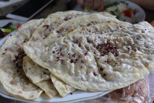 a plate of pita bread with dip on it at Ancient Lahij Guest House in Lahıc