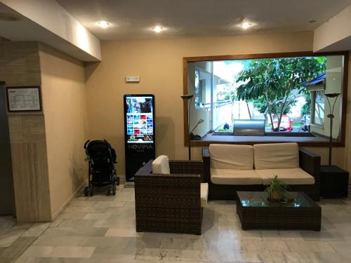 a living room with a couch and a large window at Sunny Studio In Santa Maria Aparthotel in Adeje