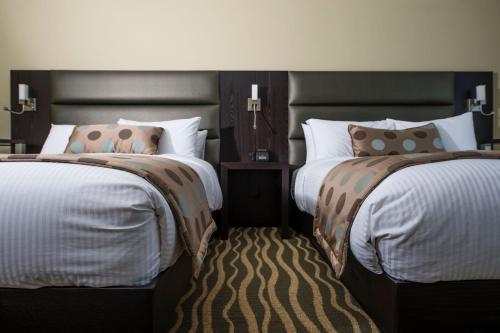 Un pat sau paturi într-o cameră la Hotel Levesque