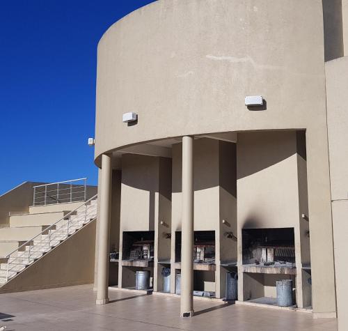 a building with columns and stairs in front of it at Encantador departamento con cochera cubierta - By BUMEN in Vicente López