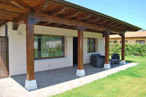 a patio with a wooden pergola at The Cool Houses in Llanes