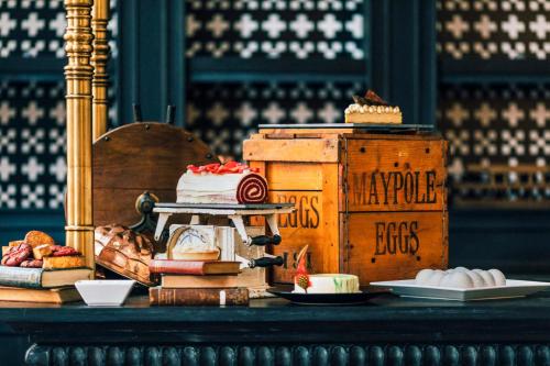a table topped with a cake and plates of food at Hotel de la Coupole - MGallery in Sa Pa