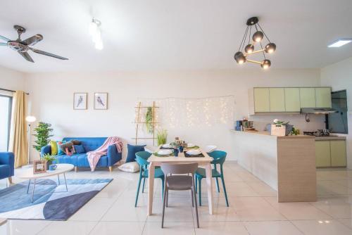 a living room with a table and a blue couch at SetiaWalk {BIG GROUP}12Pax WIFI 2C'Park IOI SUNWAY SUBANG USJ in Puchong