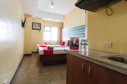 a kitchen with a bed and a sink in a room at RedDoorz @ MJ Cuenco Avenue Cebu in Cebu City