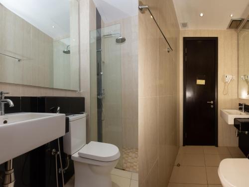 a bathroom with a toilet and a sink and a shower at MIO BOUTIQUE Hotel in Melaka