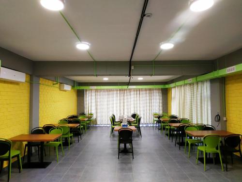 a dining room with tables and chairs and lights at ololoFreelander Hostel&Coworking in Bishkek