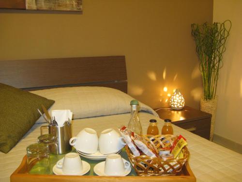 a tray with a tea set on top of a bed at B&B Li Figuli in Lecce