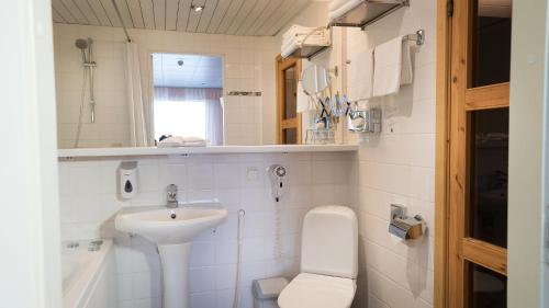 a small bathroom with a sink and a toilet at Hestia Hotel Susi in Tallinn
