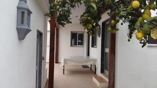 a hallway with a table with a white table cloth at Casa do carmo N 10 in Olhão