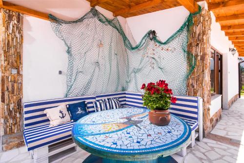 a patio with a table and a vase of flowers at Blue Breeze in Prinos