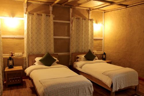 a room with two beds in a room at PaliGhar Farmstay in Kalimpong