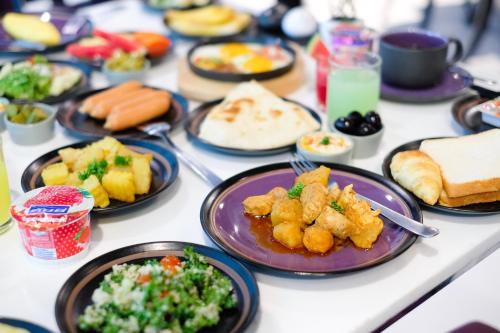 a table with plates of food on it at Aspira Skyy Sukhumvit 1 in Bangkok