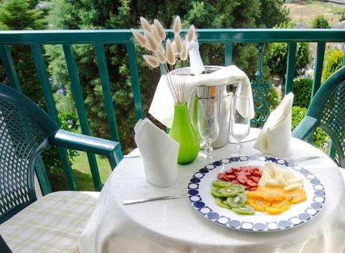 a white table with a plate of food on a table at Hotel & Apartamentos Cons da Garda in San Vicente de O Grove