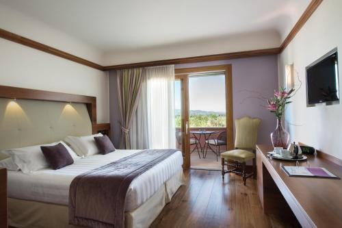 Postel nebo postele na pokoji v ubytování Valle di Assisi Hotel & Spa