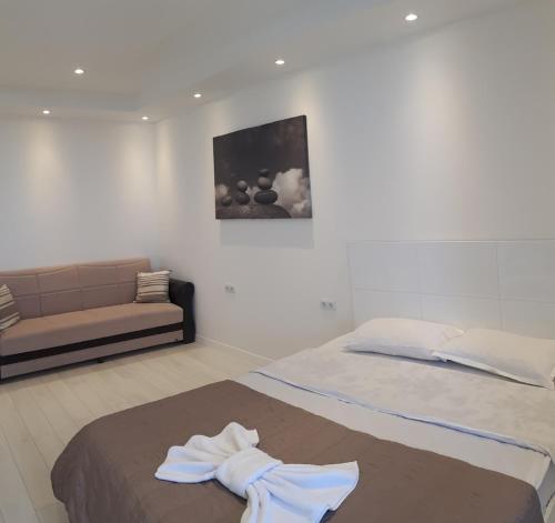 a bedroom with a bed and a couch in it at Premium Class In Batumi in Batumi