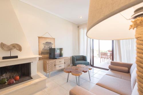 a living room with a couch and a fireplace at Afitos Hidden Gems #FeelsLikeHome in Afitos