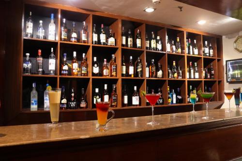 a bar with a bunch of bottles of alcohol at Le Lac Sarovar Portico- Ranchi in Rānchī