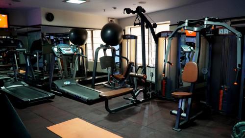 a gym with a bunch of tread machines in it at Le Lac Sarovar Portico- Ranchi in Rānchī