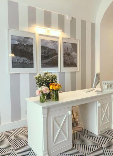 an office with a desk with flowers on it at Villa La Pergola Capri in Capri