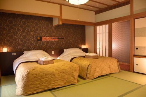 Postel nebo postele na pokoji v ubytování Kyo Yunohana Resort Suisen