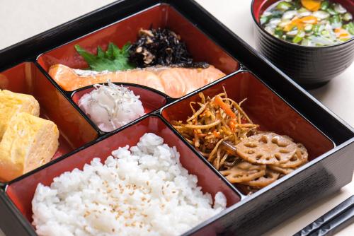 a box of food with rice and other foods at HOTEL Dior7 in Hamamatsu
