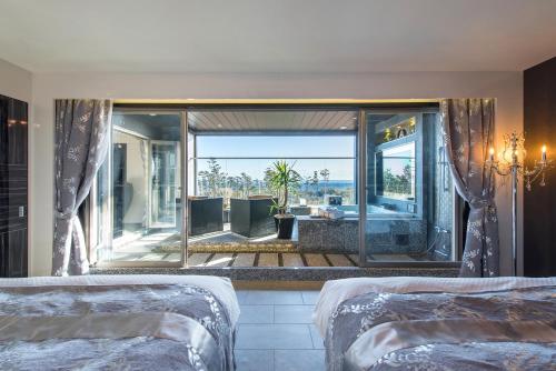 a bedroom with two beds and a large window at HOTEL Dior7 in Hamamatsu