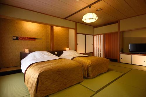 Postel nebo postele na pokoji v ubytování Kyo Yunohana Resort Suisen