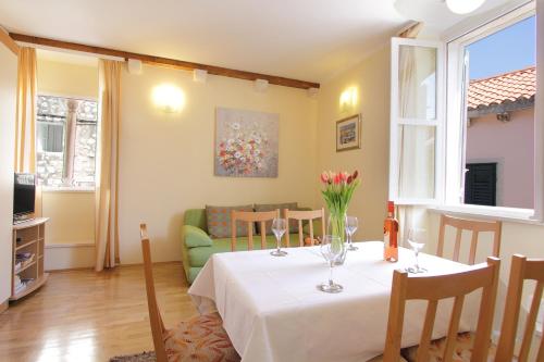 ein Wohnzimmer mit einem Tisch und Weingläsern darauf in der Unterkunft Apartments Kovac Old Town in Dubrovnik