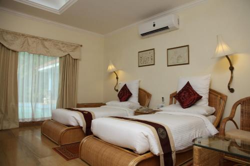 Postel nebo postele na pokoji v ubytování SAJ Earth Resort & Convention Center , Kochi