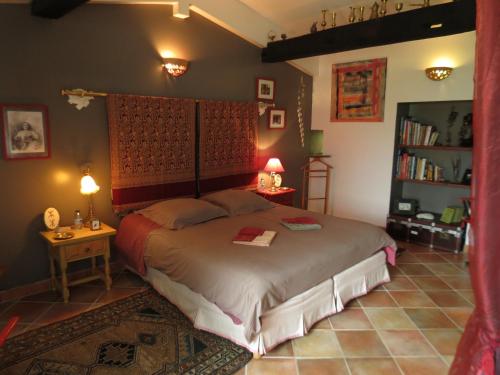 a bedroom with a bed and a book shelf at La Claverie in Sainte-Radégonde-des-Noyers