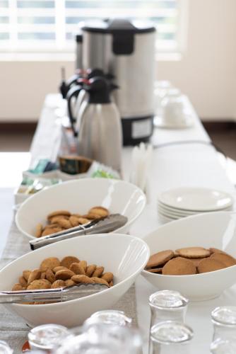 a table topped with bowls of food on a counter at Glam Hotel Nairobi - Near Westgate Mall, Westlands in Nairobi