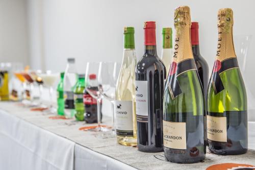 a row of bottles of wine sitting on a table at Glam Hotel Nairobi - Near Westgate Mall, Westlands in Nairobi