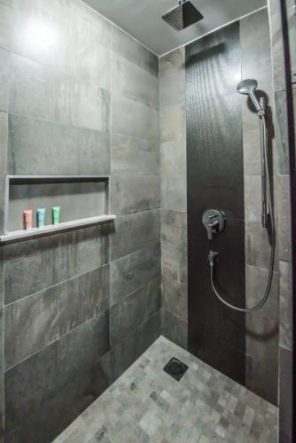 a bathroom with a shower with a glass door at Glam Hotel Nairobi - Near Westgate Mall, Westlands in Nairobi