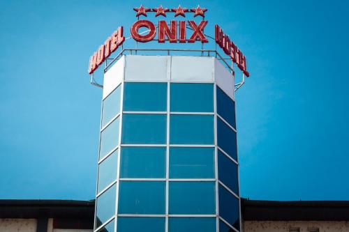 a blue and white sign on a building at Hotel Onix in Cluj-Napoca