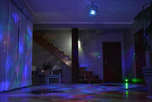 a room with purple lights and a stairway at Dom na Mazurach LUNA HAUS in Ełk