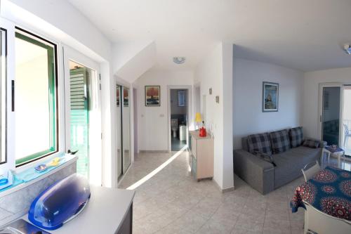 a living room with a couch and a table at Beach Apartments Rogoznica in Rogoznica