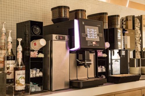 a coffee machine on a counter with bottles of wine at Kobe Motomachi Tokyu REI Hotel in Kobe