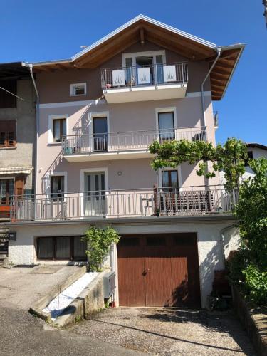 an apartment building with a garage in front of it at La Casa di Olivo in Tassullo