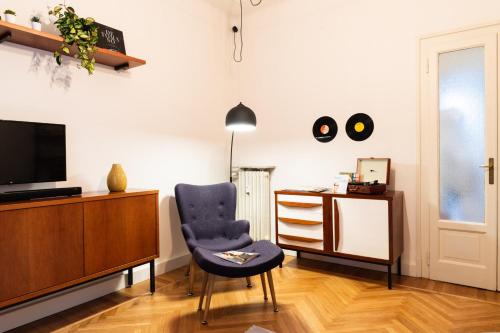 a living room with a chair and a desk at ReGo Holiday Apartments City Center in Bergamo