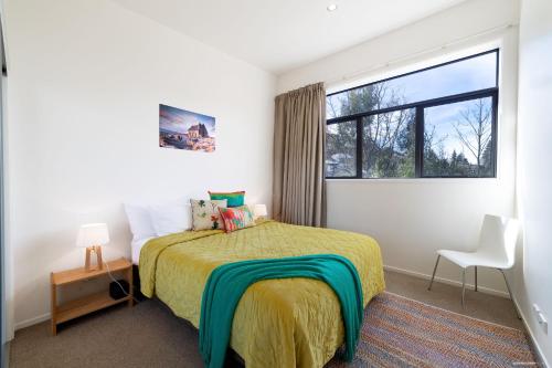 a bedroom with a bed and a large window at @MyHolidays - My Remarkable view in Queenstown