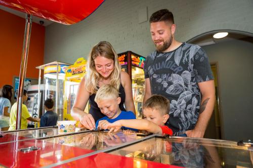 a woman and two children looking at a glass counter at Camping Pods, Golden Sands Holiday Park in Dawlish