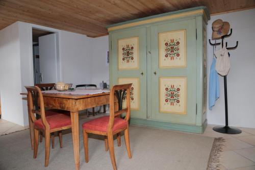 a dining room with a wooden table and chairs at Rustico in Verdabbio