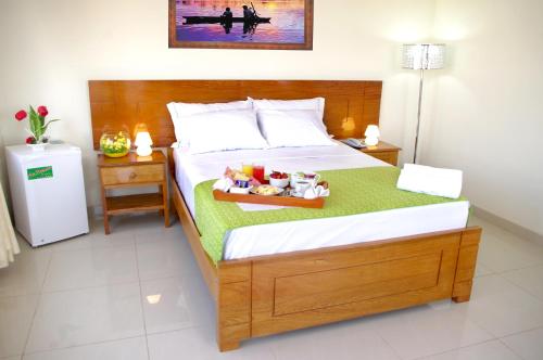 a bedroom with a bed with a tray of toys on it at Del Castillo Plaza Hotel Pucallpa in Pucallpa