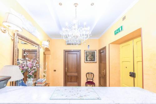 a dining room with a chandelier and a table at Downtown Accommodation in Rome