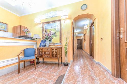 a hallway with a mirror and a desk and a chair at Downtown Accommodation in Rome