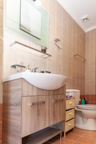 a bathroom with a sink and a toilet at Nina Apartment in Chania Town