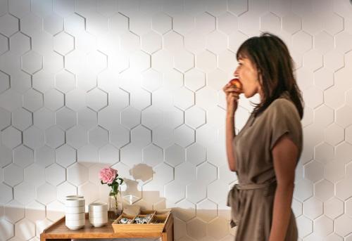 a woman standing in a room eating food at Hostal Blanca in Can Picafort