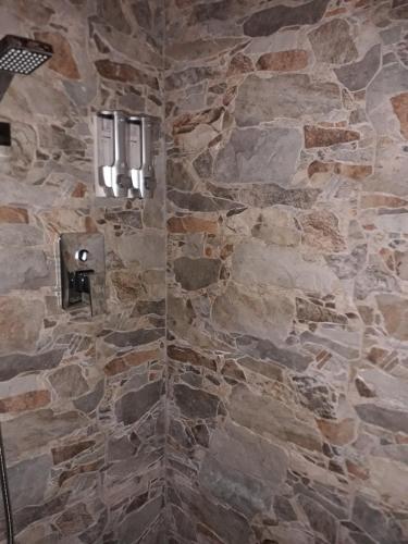 a stone bathroom with a stone wall with a window at Casa Caterina in La Spezia